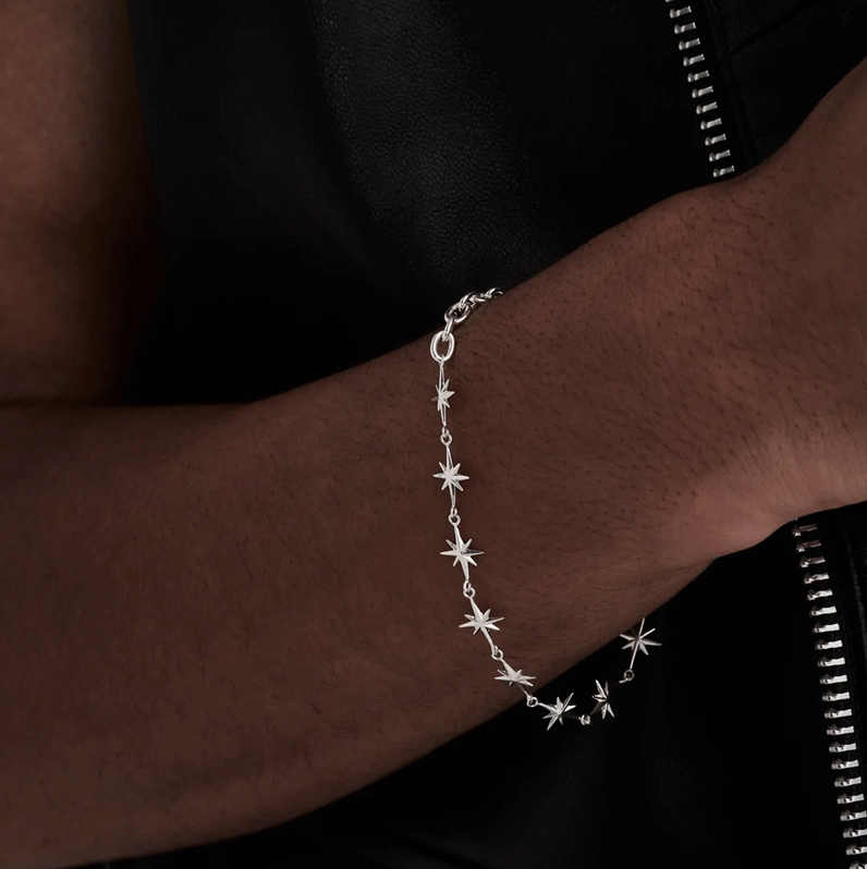 Silver star bracelet hanging off a wrist 